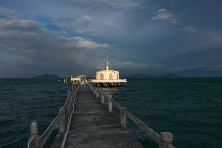 Pier leading to the pagoda on the beachの写真素材