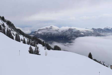 Snow on the top of the mountains and beautiful views down the valleyの写真素材