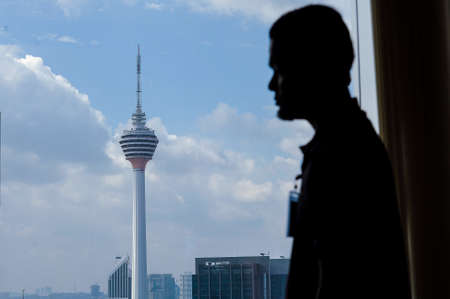 Kuala Lumpur, December 14, 2016. A man seen near Malaysia iconic building Kuala Lumpur Tower.