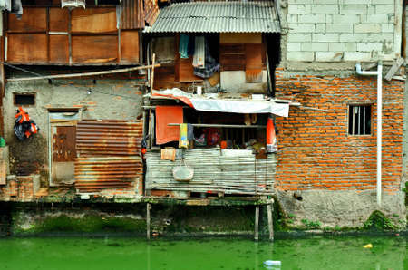 Poor area with Slum house on the edge of a canal in Jakarta, Indonesia