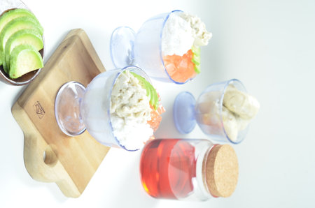 Avocado ice cream in a glass on a white background, top view