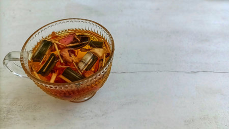 Traditional healthy Indonesian Jamu drink with turmeric, ginger, lemongrass, secang, and lime....