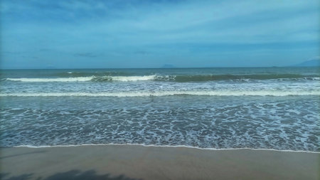 Panoramic view of a calm blue sea with a distant shoreline and expansive sky. Scenic ocean horizon...