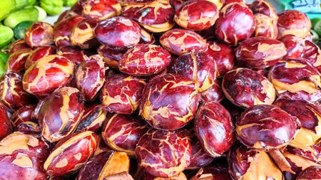 Large Pile of Fresh Jengkol Beans or Archidendron Pauciflorum Displayed at a Local Indonesian Marketの写真素材