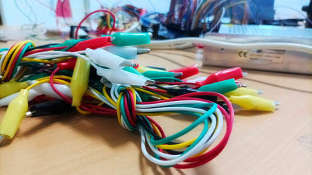 Macro Close-up View of Various Colored Alligator Clips and Insulated Wires for Electronic Testing...