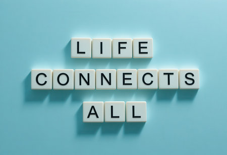 Inspirational message "Life Connects All" displayed with letter tiles on a blue background, symbolizing unity and positive connections among people and ideas.の素材