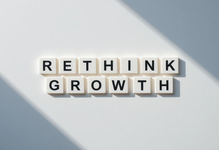 A creative arrangement of letter tiles spelling "RETHINK GROWTH" on a minimalist surface, emphasizing new ideas and innovative strategies for personal and professional development.の素材