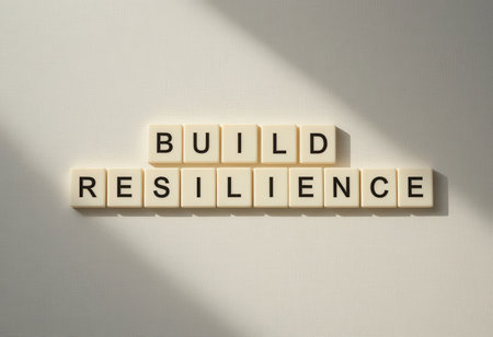 A minimalist image displaying the words "Build Resilience" in letter tiles, symbolizing the importance of mental strength and personal growth in overcoming challenges.の素材