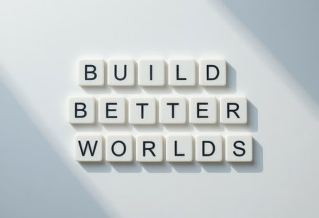 A clean and modern arrangement of letter tiles spelling "Build Better Worlds" on a white surface, symbolizing hope, growth, and inspiration for positive change.の素材
