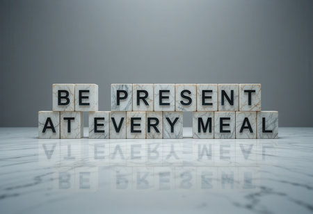 A serene image of marble blocks with the phrase "Be Present at Every Meal," encouraging mindfulness and appreciation during dining experiences.の素材