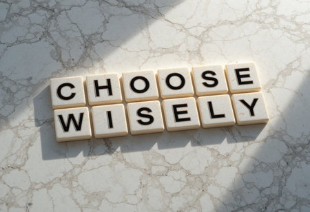 Engaging motivational quote "Choose Wisely" displayed with black letters on a white marble surface. Ideal for themes of decision-making and personal growth.の素材
