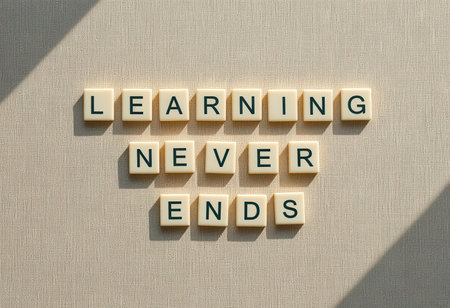 A creative arrangement of letter blocks spelling "Learning Never Ends" showcases the concept of continuous education and personal growth, set against a textured background.の素材