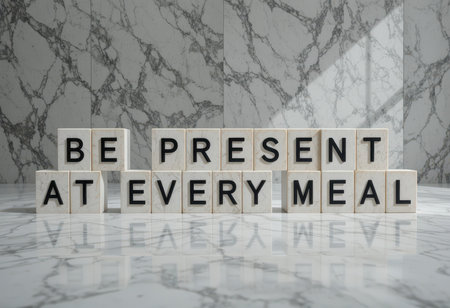 This stock photo features a stylish arrangement of letter blocks on a marble countertop, delivering an inspirational message about being present at every meal.の素材