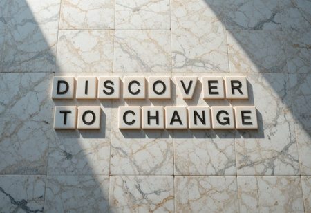 This image features tiles spelling the inspiring message "Discover to Change" on a marble background, enhanced by natural light and shadow. Perfect for themes of transformation.の素材