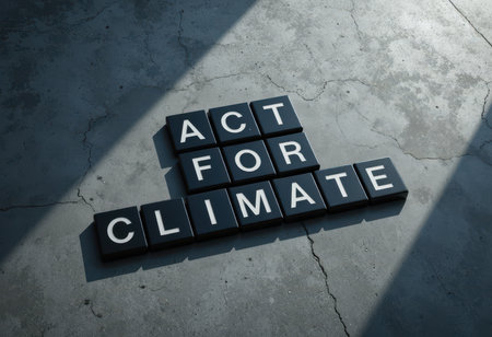 A striking arrangement of black tiles with white letters spelling "ACT FOR CLIMATE" on a concrete floor, emphasizing the urgent need for climate action and awareness.の素材
