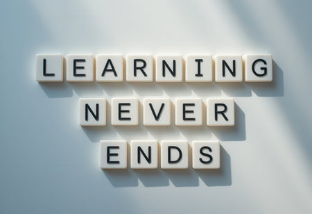 Inspirational phrase "Learning Never Ends" made of letter tiles on a soft, illuminated background. Ideal for concepts of education, growth, and motivation.の素材