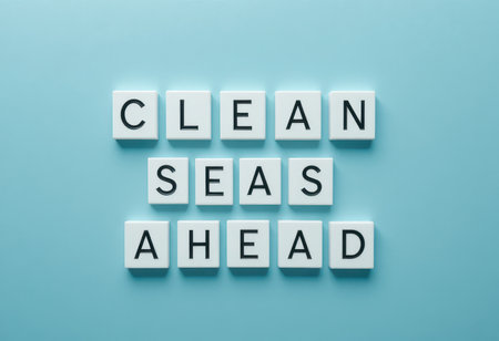 The image showcases letter tiles arranged to spell "Clean Seas Ahead" on a soothing blue background, emphasizing environmental awareness and positivity for a sustainable future.の素材