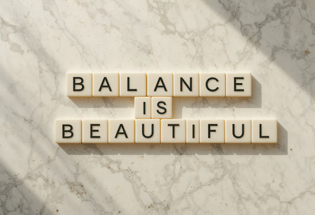 A serene composition featuring letter tiles spelling "Balance is Beautiful" on a marble surface, ideal for promoting mindfulness and positivity.の素材