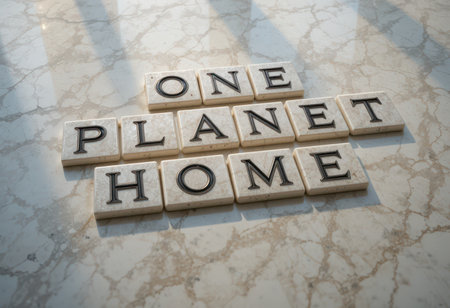 An artistic arrangement of tiles spelling "ONE PLANET HOME" on a sleek marble surface. This image promotes environmental awareness and unity.の素材
