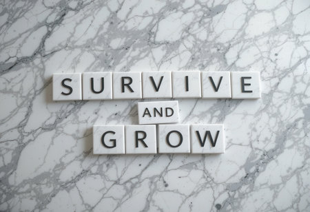 An engaging flat lay featuring letter tiles arranged on a marble background, conveying the powerful message to "Survive and Grow," emphasizing motivation and resilience.の素材