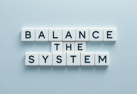 A creative display of letter tiles spelling out the phrase "Balance the System" on a light background, symbolizing clarity and harmony in ideas and design.の素材