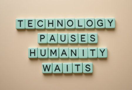 A creative representation of the phrase "Technology pauses humanity waits" using lettered tiles on a soft background. This art piece invites reflection on society's relationship with technology.の素材