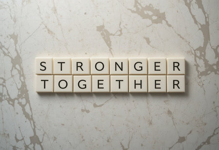 This image features letter tiles spelling "Stronger Together," symbolizing unity and collaboration. Ideal for themes of teamwork and empowerment in various contexts.の素材