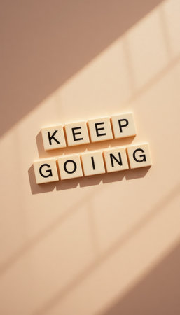 A motivational image featuring the words "Keep Going" in block letters against a soft background, embodying positivity and encouragement for personal growth and perseverance.の素材