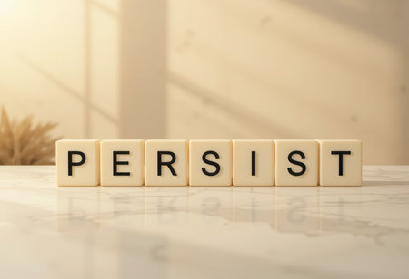 A close-up view of the word "Persist" made from letter blocks, symbolizing motivation and determination. This inspiring image captures sunlight, ideal for creative and motivational projects.の素材