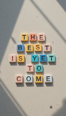 A vibrant arrangement of colorful letter tiles spelling an uplifting phrase, set against a light background. Perfect for motivational and inspirational themes.の素材