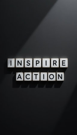 A striking visual featuring the words "Inspire Action" created with letter tiles on a sleek black background, showcasing motivation and creative energy.の素材