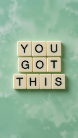 A vibrant green background showcases a motivational phrase created with letter tiles. Ideal for promoting positivity and encouragement in personal or professional spaces.の素材