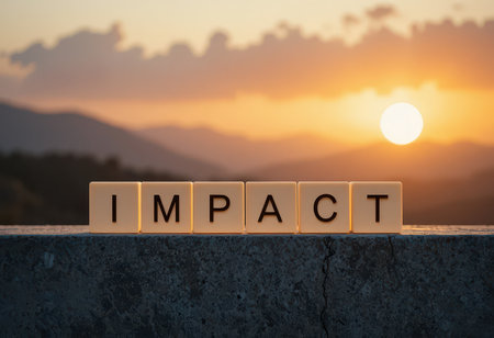 A beautiful sunset casts a warm glow over mountains, highlighting the word 'IMPACT' made from blocks. This scene evokes feelings of inspiration and positivity.の素材