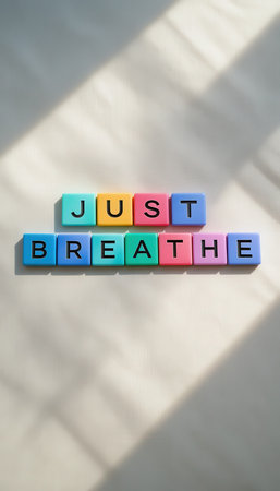 Colorful plastic blocks spell out the motivational phrase "Just Breathe," creating an uplifting atmosphere. Perfect for promoting relaxation and mindfulness in contemporary spaces.の素材