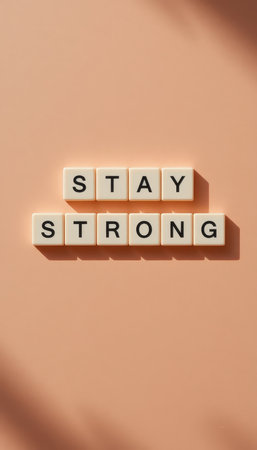 A motivational design featuring the words "Stay Strong" in clean typography on a soft pink background. Perfect for inspiration and positivity.の素材