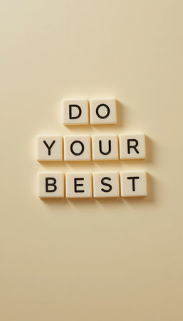 A creative composition featuring letter tiles arranged to spell an inspirational message on a neutral background. Perfect for promoting positivity and motivation.の素材