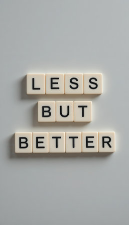 A minimalistic design featuring the motivational phrase "Less but Better" on a gray background. This concept emphasizes simplicity and clarity in life.の素材