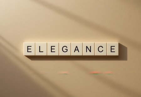 This image features elegant letter tiles arranged to spell the word "elegance" on a soft, light background. The minimalist design and subtle shadows enhance its artistic appeal.の素材