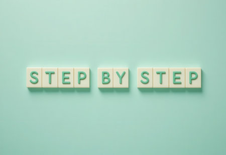A creative arrangement of text reading "Step By Step" on a soothing light blue background, ideal for conveying motivation and guidance in personal development.の素材