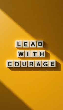 A dynamic image showcasing letter blocks spelling "Lead with Courage" on a vibrant yellow background, perfect for inspiring individuals and teams in any setting.の素材