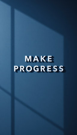 A visually striking image featuring the phrase "Make Progress" cast in shadow on a dark blue wall, symbolizing motivation and personal growth. Perfect for inspiring content.の素材