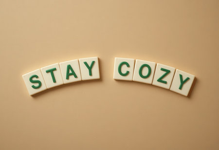 A charming display of green letters spelling "Stay Cozy" against a soft beige background, perfect for conveying a message of warmth and comfort in any space.の素材