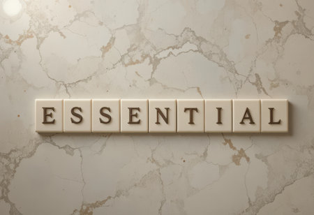 A captivating image displaying the word "ESSENTIAL" crafted with tile letters on a sophisticated marble background, ideal for design and communication themes.の素材