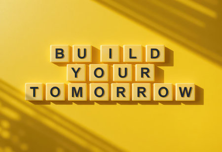 A vibrant yellow background features the inspiring phrase "Build Your Tomorrow" formed by bold letters. This design promotes positivity and motivation for future success.の素材