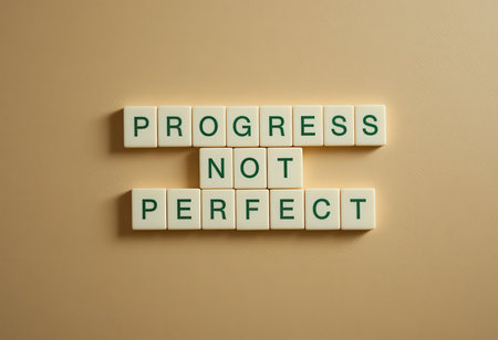 An inspiring message emphasizing progress over perfection, set against a simple light background. Ideal for personal growth, motivation, or self-help themes.の素材