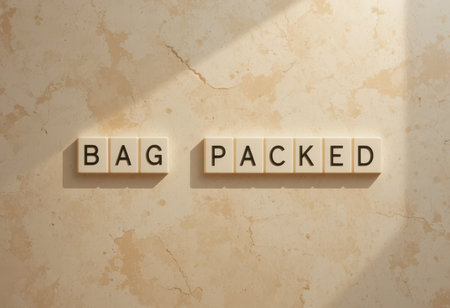 Artistic arrangement of letter tiles spelling "Bag Packed" on a textured background, capturing the essence of travel preparation. Ideal for travel-themed projects.の素材