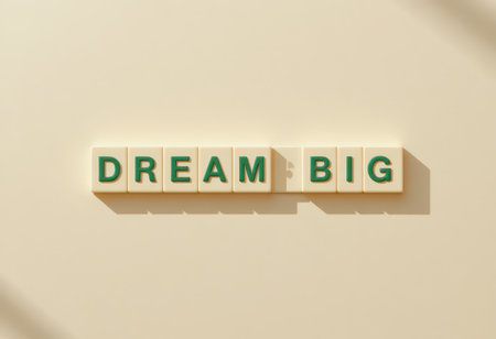 Inspiring image featuring the phrase "Dream Big" displayed on tiles against a soft backdrop. Perfect for motivation, personal growth, or educational themes.の素材