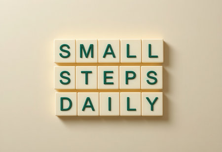 A visually appealing arrangement of tiles displaying the motivational phrase "Small Steps Daily." This inspiring image encourages personal growth and consistent progress. Perfect for wellness and self-improvement themes.の素材