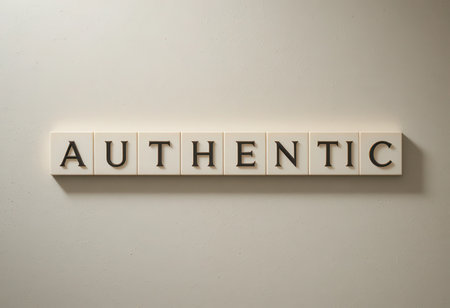 The image showcases the word "AUTHENTIC" arranged in letters against a neutral wall, symbolizing core values such as truth and integrity in minimalistic design.の素材
