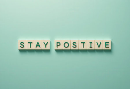 A visually appealing arrangement of wooden letters spelling "Stay Positive" against a mint green background, perfect for promoting positivity and motivation in any space.の素材